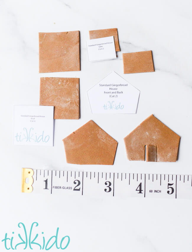 Pieces of a miniature gingerbread house next to a ruler for scale.
