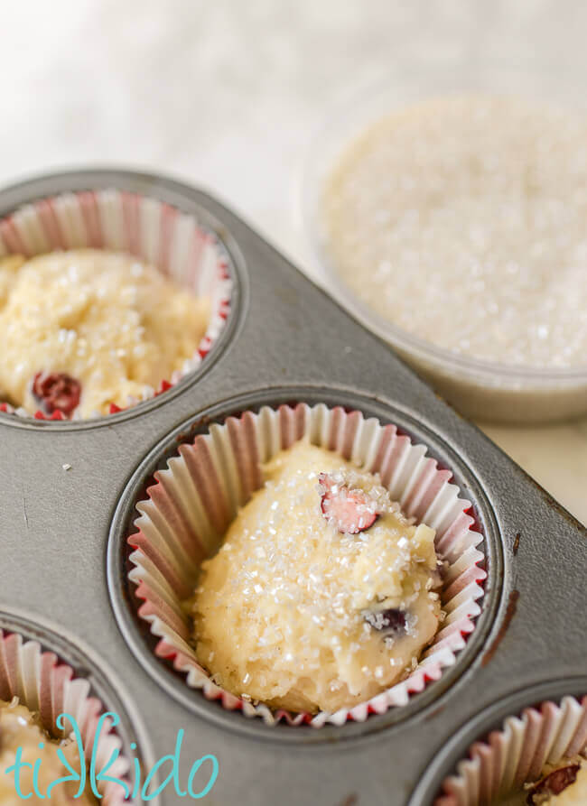 Cranberry muffins batter sprinkled with coarse sugar before baking.