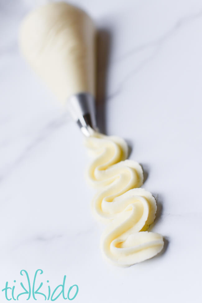 Cream cheese frosting swirled from an icing bag fit with an open star tip.