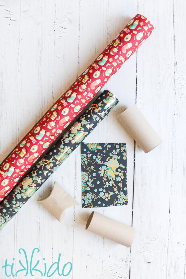 Rolls of gift wrap, and wrapping paper cut into a rectangle to make a pillow box favor.