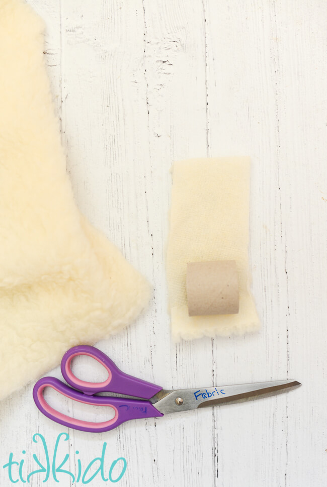 Faux shearling fabric being cut to make Easter napkin rings that look like sheep.