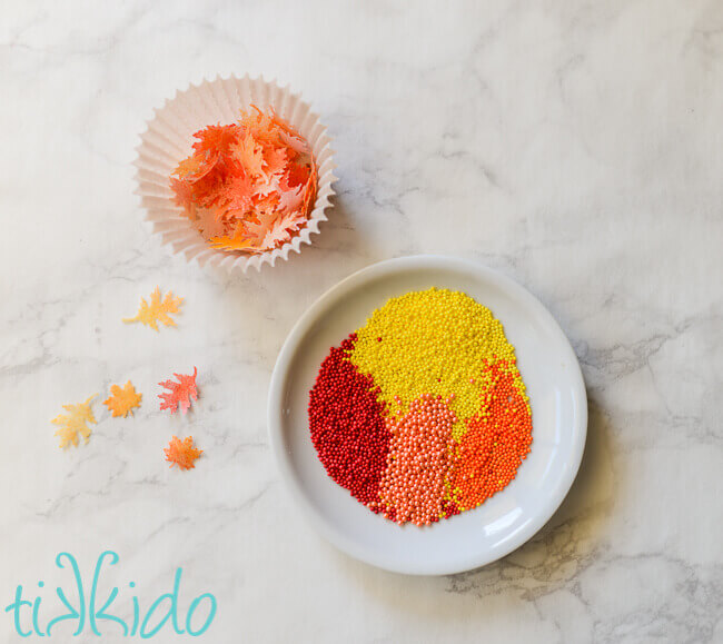 Small edible fall leaves made from wafer paper and sprinkles in fall colors.