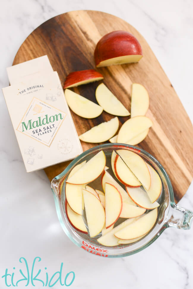 Apple slices soaking in salt water to keep the apples from browning.