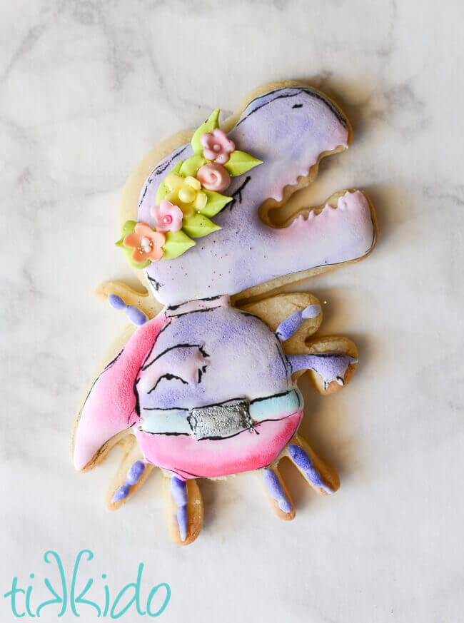 Dinomite GISHWHES 2015 mascot sugar cookie in pastel colors on a white marble background