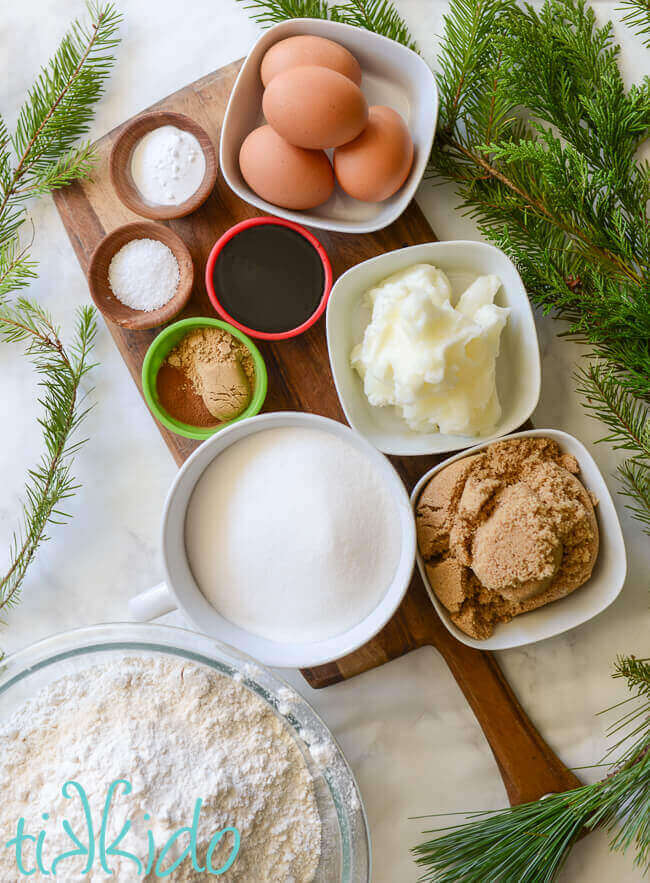 Gingerbread house recipe ingredients on a wooden cutting board.