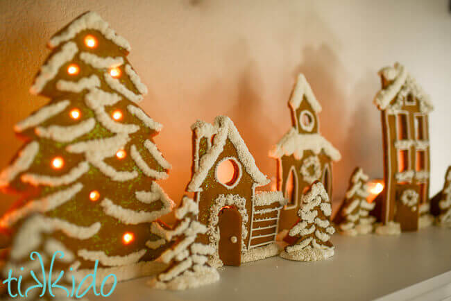 Gingerbread House Candle Holders on a fireplace mantel.
