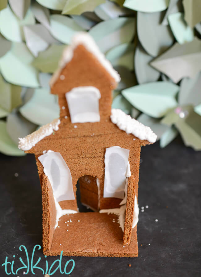 Back view of a gingerbread house candle holder for the gingerbread town mantel.