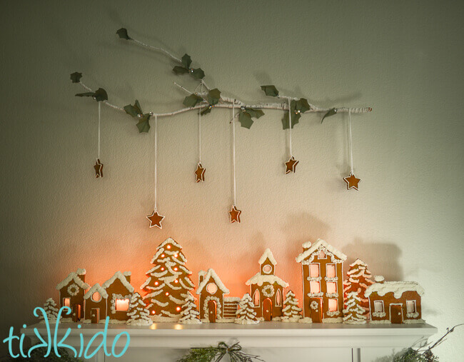 Gingerbread House Candle Holders making a gingerbread town on a fireplace mantel.