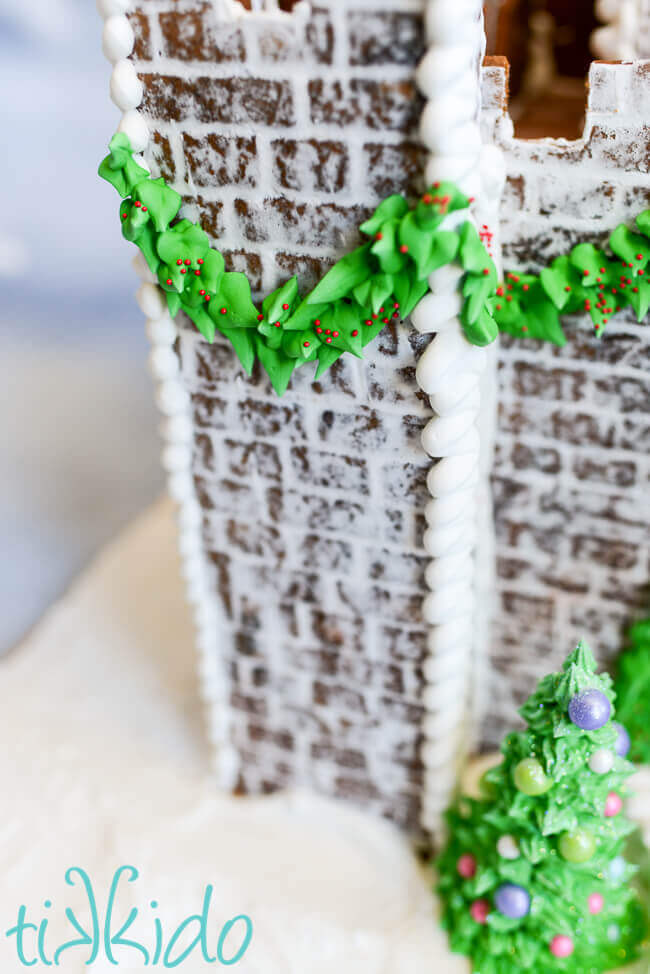 Detail shot of brick impressions and royal icing garland on the gingerbread castle.