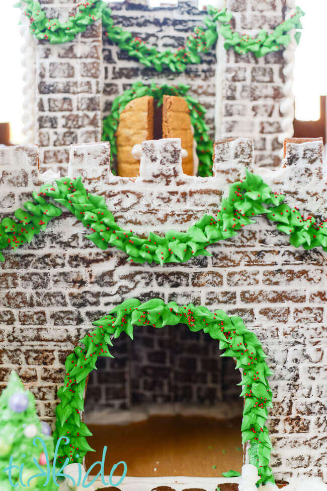 Detail shot of a gingerbread castle with royal icing garlands.
