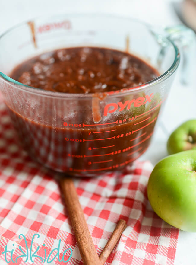 Instant Pot Apple Butter Recipe in a pyrex measuring cup before reducing and thickening.