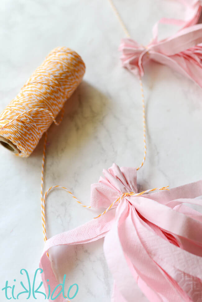 Tissue paper tassel gathered and tied in place with some yellow and white baker's twine.