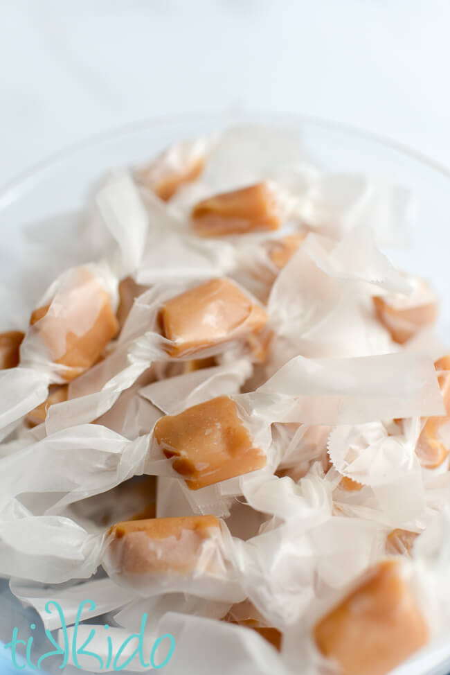 Homemade caramels made with a Salted Caramels Recipe wrapped in waxed paper.