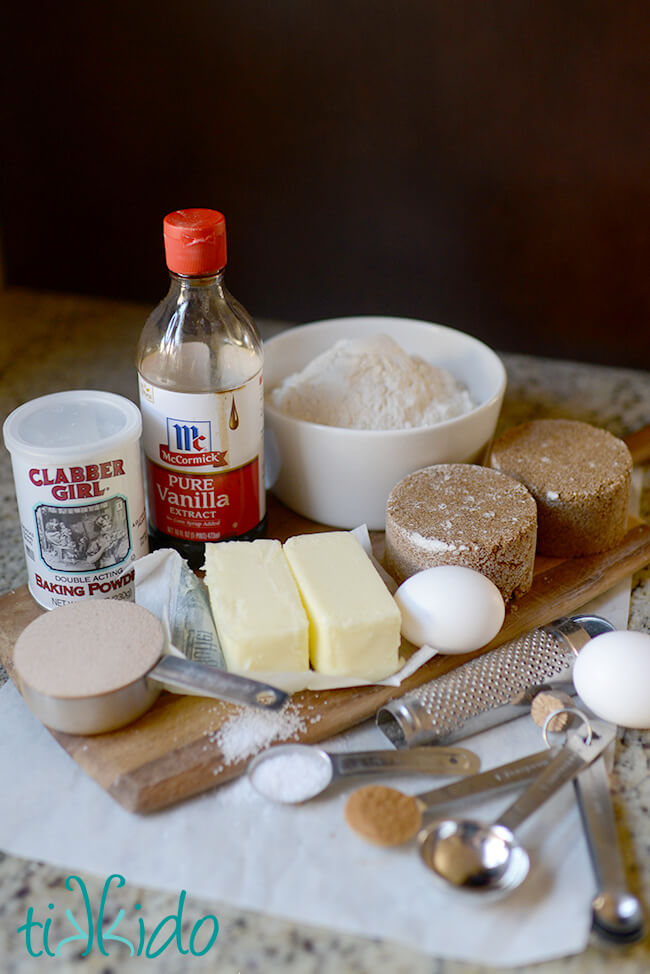 Ingredients for Snickerdoodle Blondies recipe measured out and arranged on parchment paper on a granite countertop.