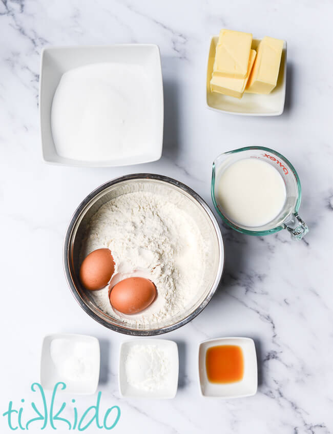 Ingredients for Soft Sugar Cookie recipe on a marble surface.