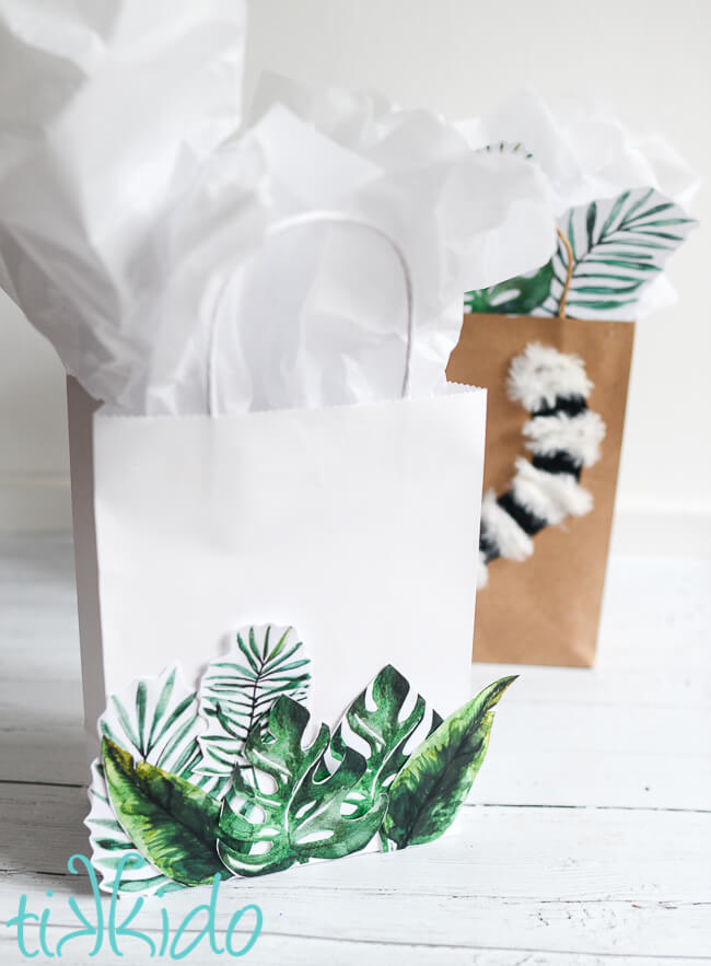 DIY Tropical Gift Bag in front of a lemur gift bag on a white wooden surface.