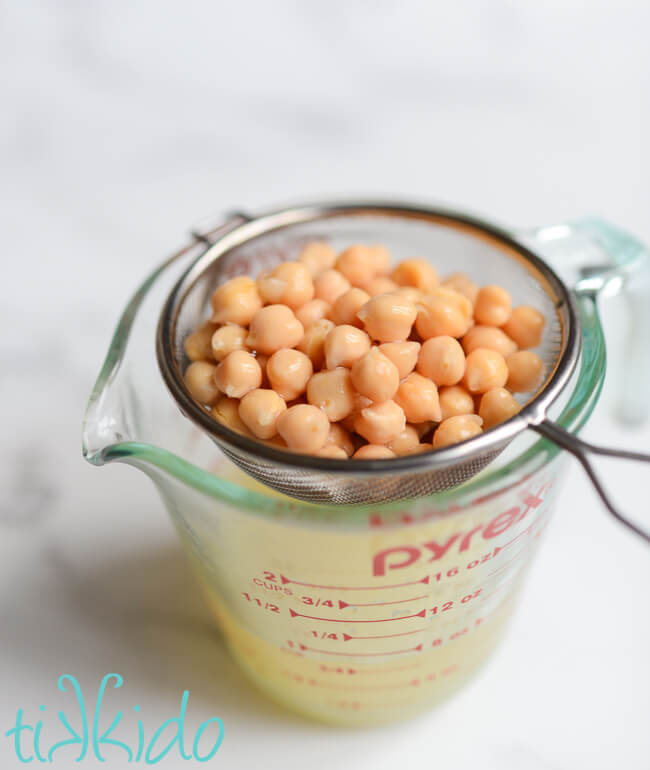 Chickpeas being drained to gather aquafaba to make vegan royal icing.