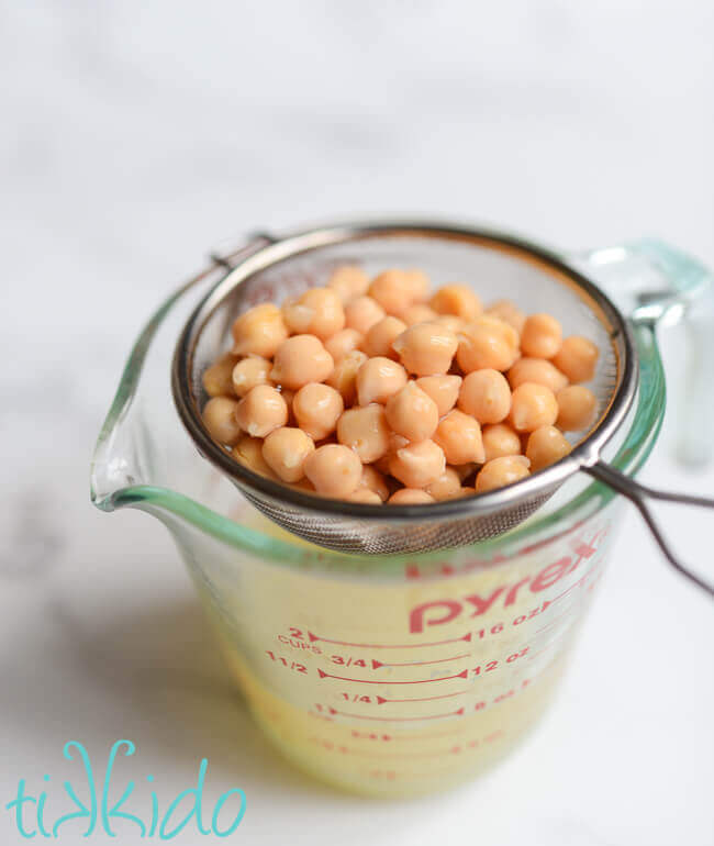 Chickpeas being drained to use the aquafaba for making vegan gingerbread.