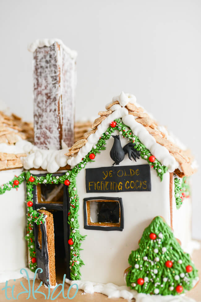 Closeup of the door and sign of the gingerbread Ye Olde Fighting Cocks Pub.