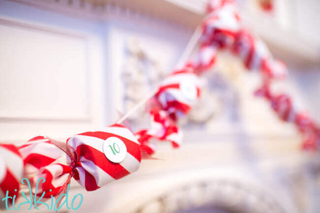 DIY Advent Calendar garland hanging on a fireplace mantel.