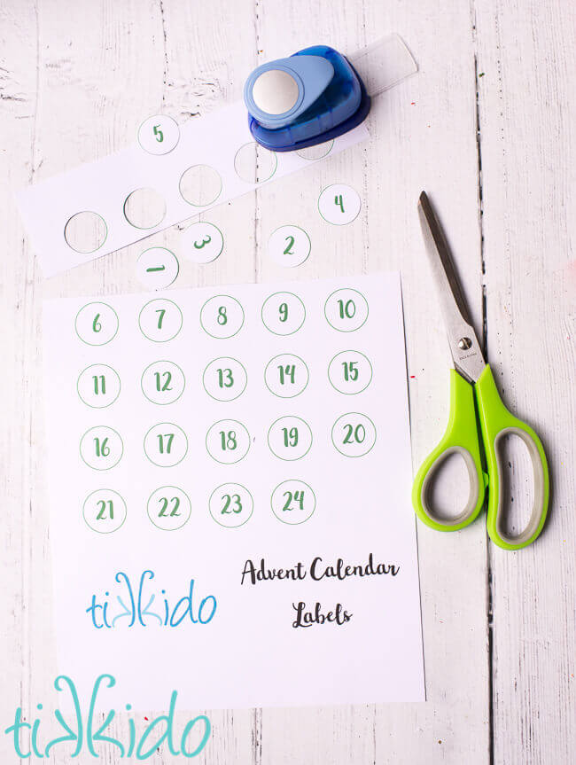Free printable DIY advent calendar labels being cut out.