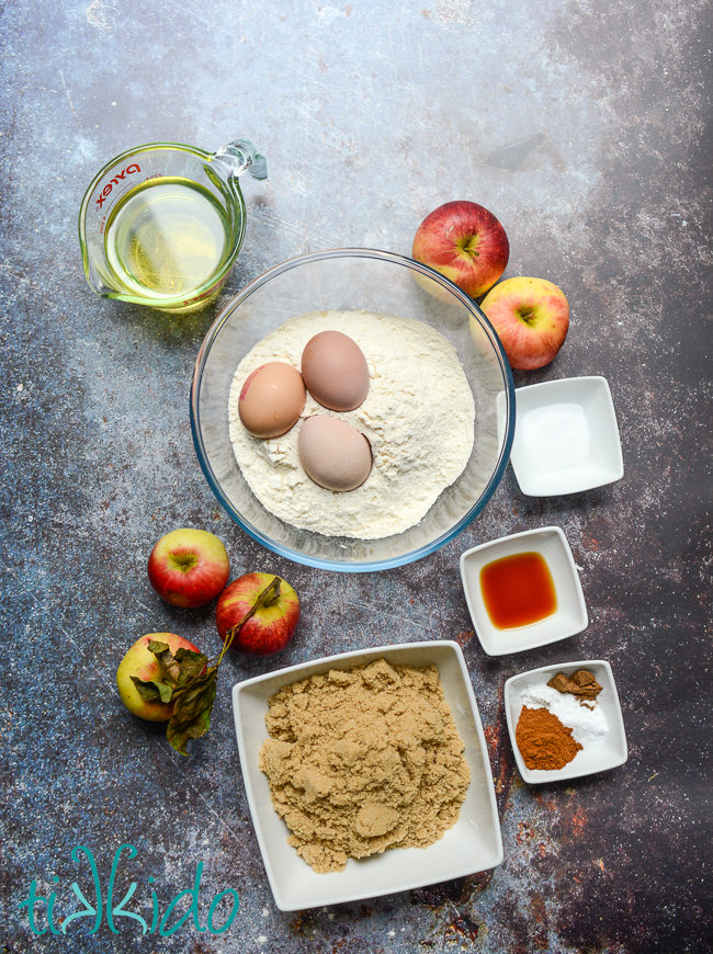 Ingredients for Apple Bread Recipe on a grey concrete surface.