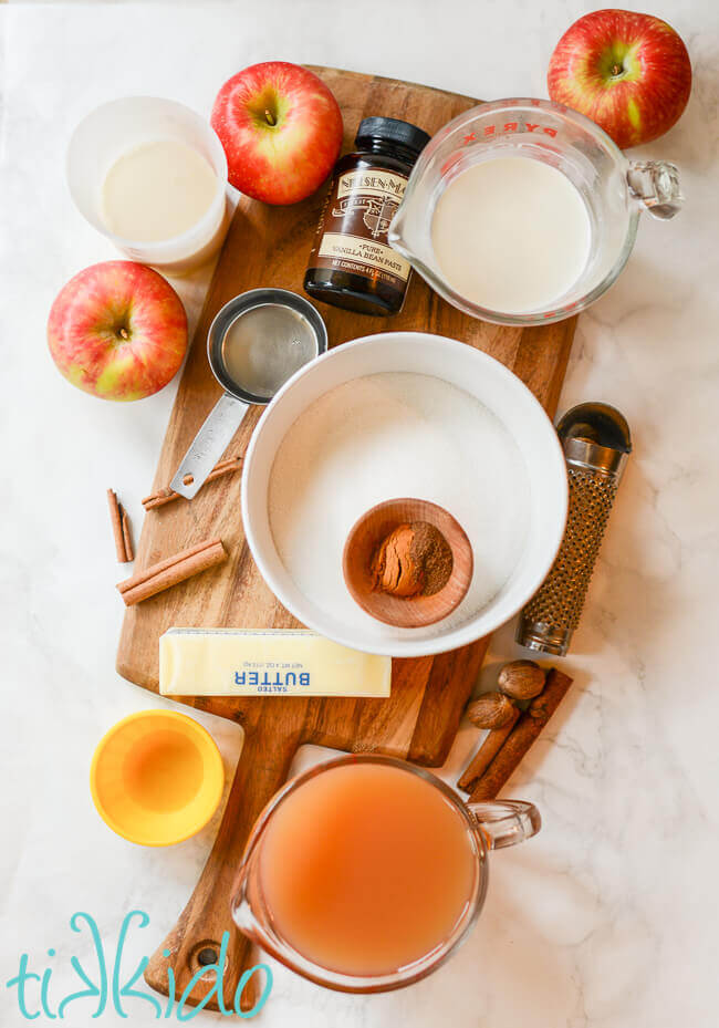 Ingredients for apple cider caramels on a wooden cutting board.