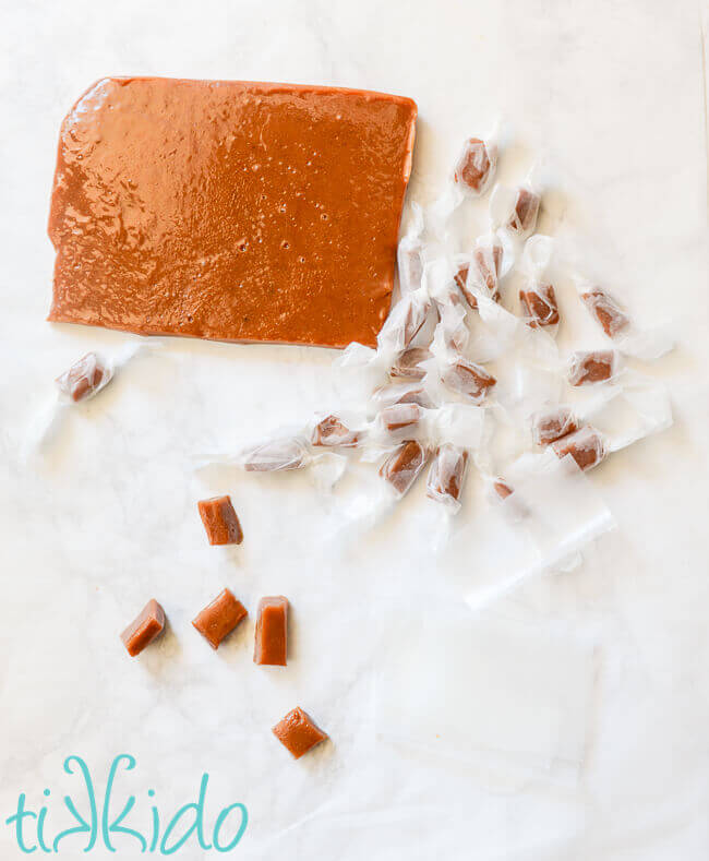 Apple Cider Caramels being wrapped in waxed paper.