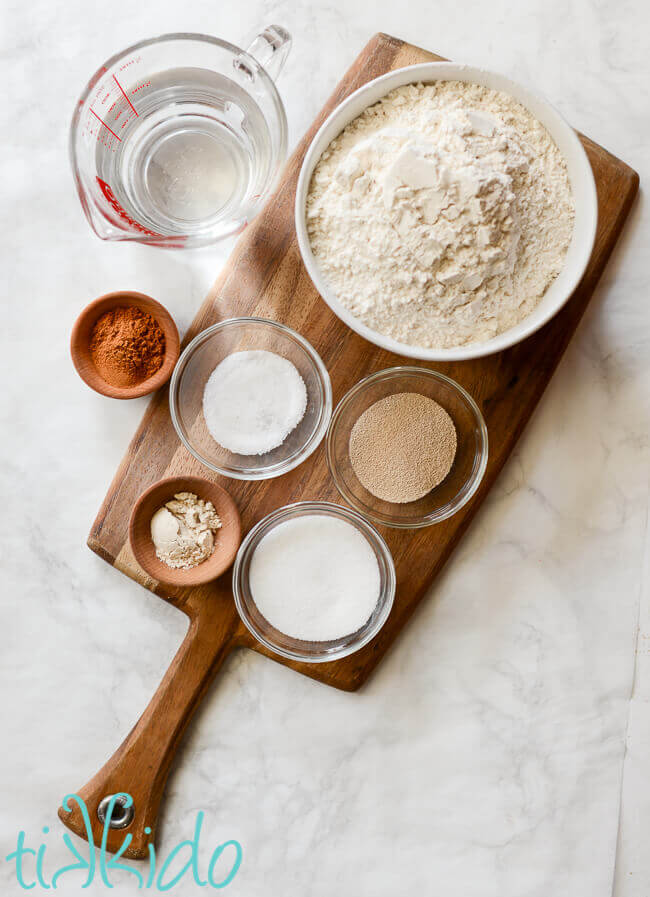 Cinnamon sugar bagel ingredients on a wooden cutting board.