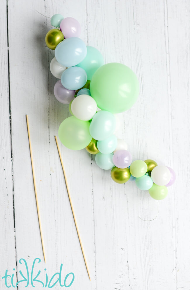 Mini balloons strung on wire to make a Balloon Garland Cake Topper.
