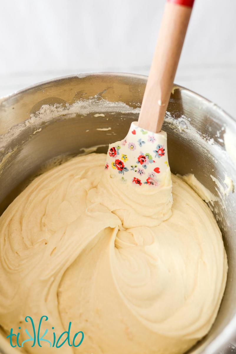 Blackberry Pound Cake Recipe Bowl of vanilla pound cake batter with a floral-print spatula.