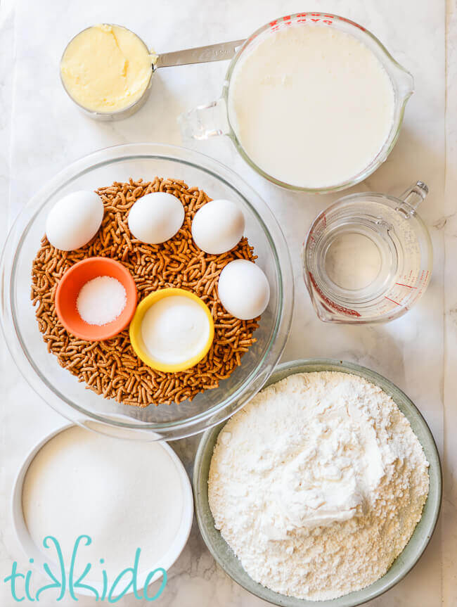 Ingredients for bran muffins on a white marble background.