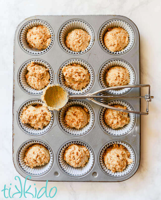 Bran muffin batter scooped into lined muffin tin.