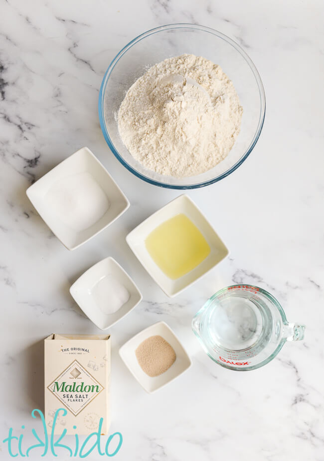 Ingredients for auntie anne's pretzel recipe made in a bread machine on a white marble surface.