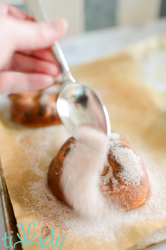 Cinnamon sugar being sprinkled on an Auntie Anne's copycat pretzel.