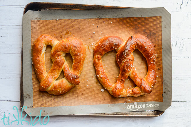 Baking sheet with two large Auntie Anne's copycat pretzel recipe pretzels freshly baked.