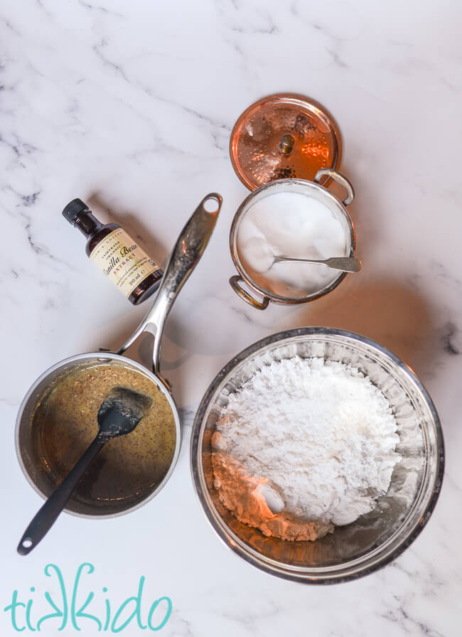 Ingredients for Browned Butter Frosting on a white marble surface.