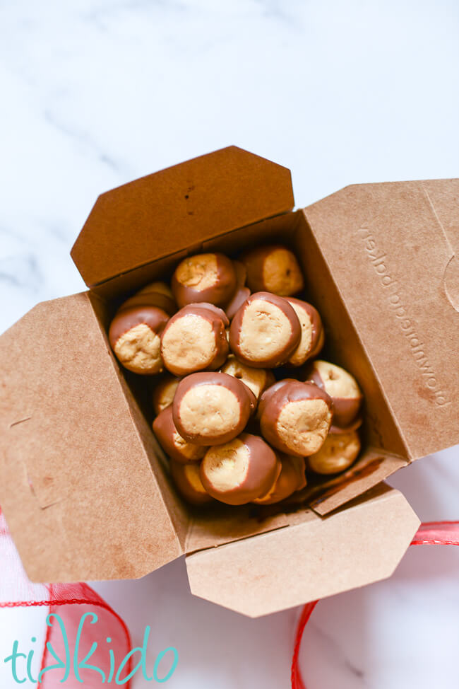 Brown kraft box filled with chocolate covered peanut butter balls (buckeye candies).