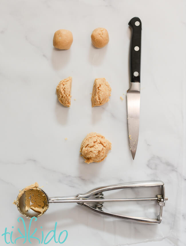 Peanut butter balls for Buckeye Candy being shaped into balls.