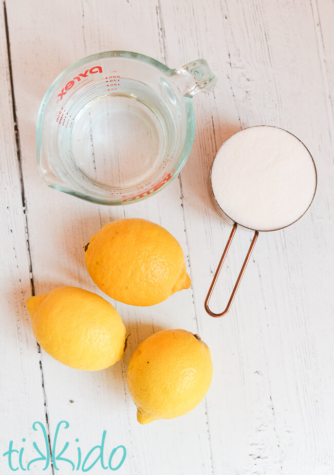 Lemon Cake Soak Recipe ingredients on a white wooden surface.