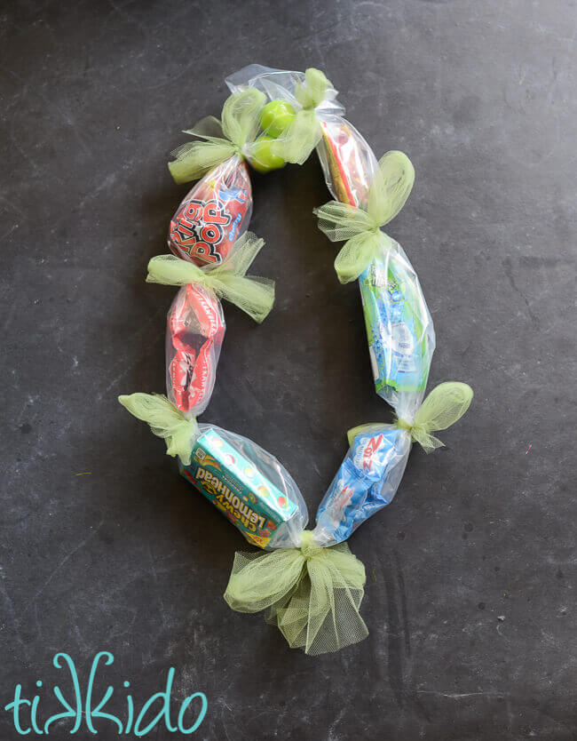 Plastic tubing filled with candy and tied with tulle bows to make a simple Hawaiian candy lei.