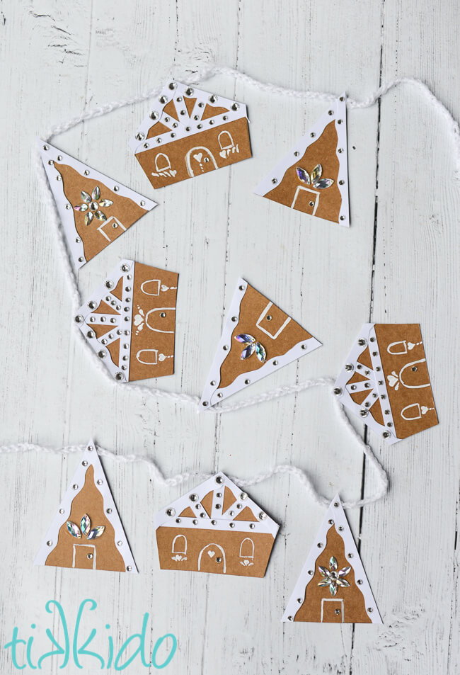 Gingerbread House Christmas Garland made out of cardboard and paper.