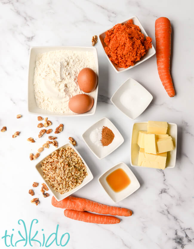 Carrot Cake Cookie recipe ingredients on a white marble surface.