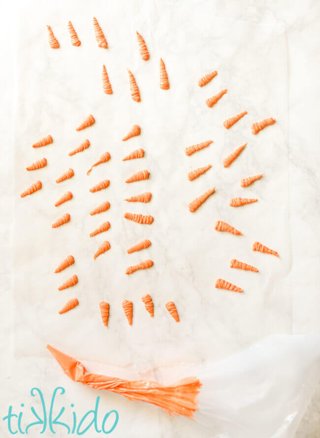 The orange section of small carrots made out of melted chocolates.