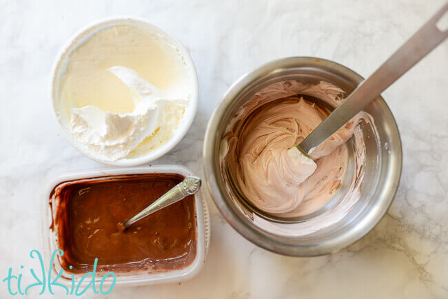 Three containers, one with chocolate pudding, one with Cool Whip, and one bowl with a spatula and the two mixed together to make chocolate Cool Whip.