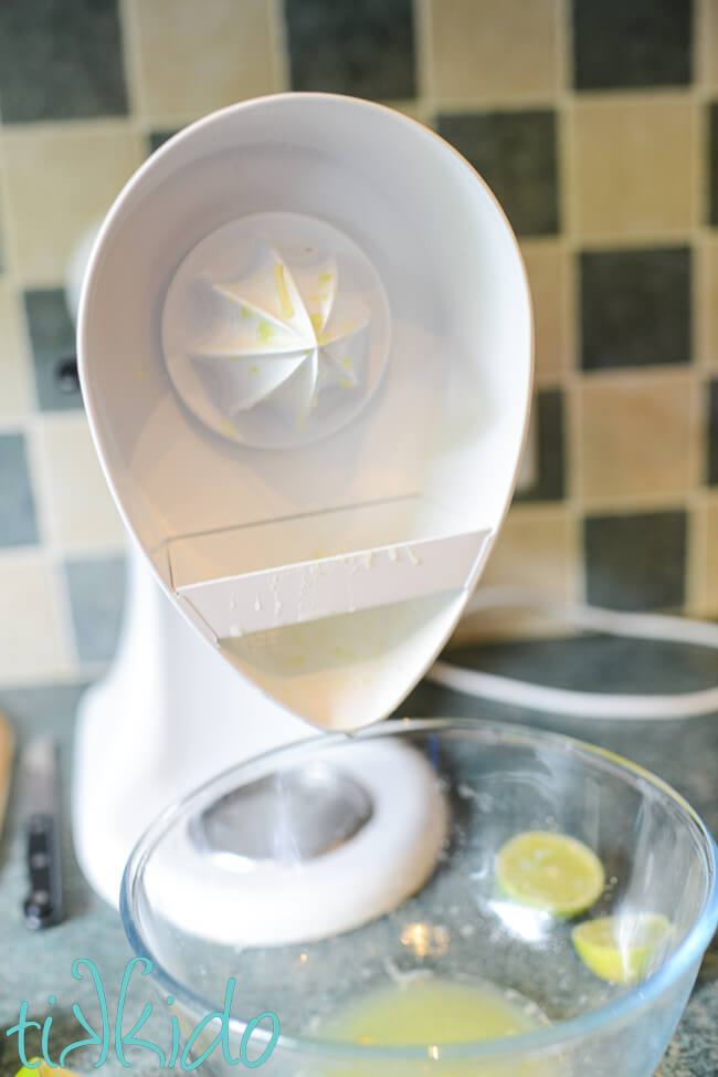 Limes being juiced with a Kitchenaid juicer attachment.