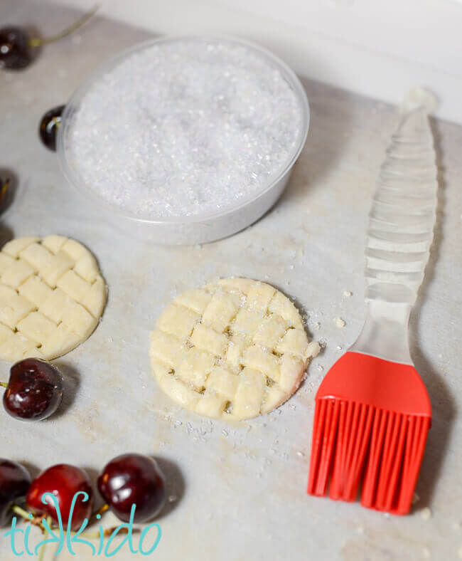 Pie crust garnish for a cherry pie milkshake being sprinkled with coarse sugar.