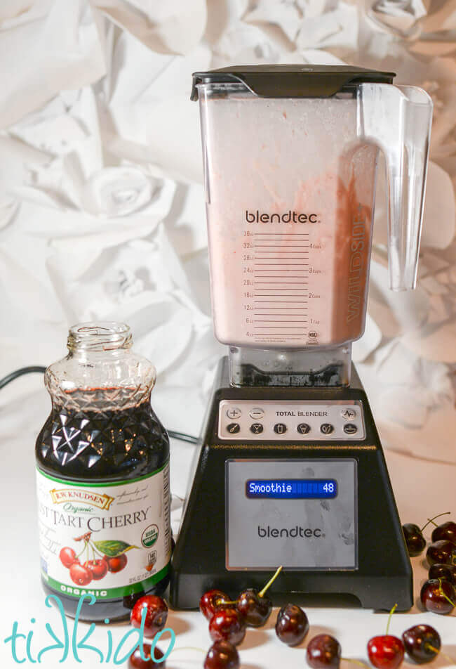 Tart cherry juice and vanilla ice cream being blended together to make a cherry milkshake.