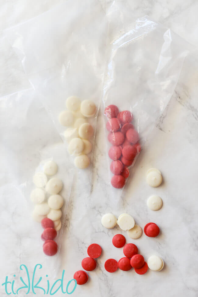 red and white melting chocolates being used to make Valentine's day cupcake toppers.