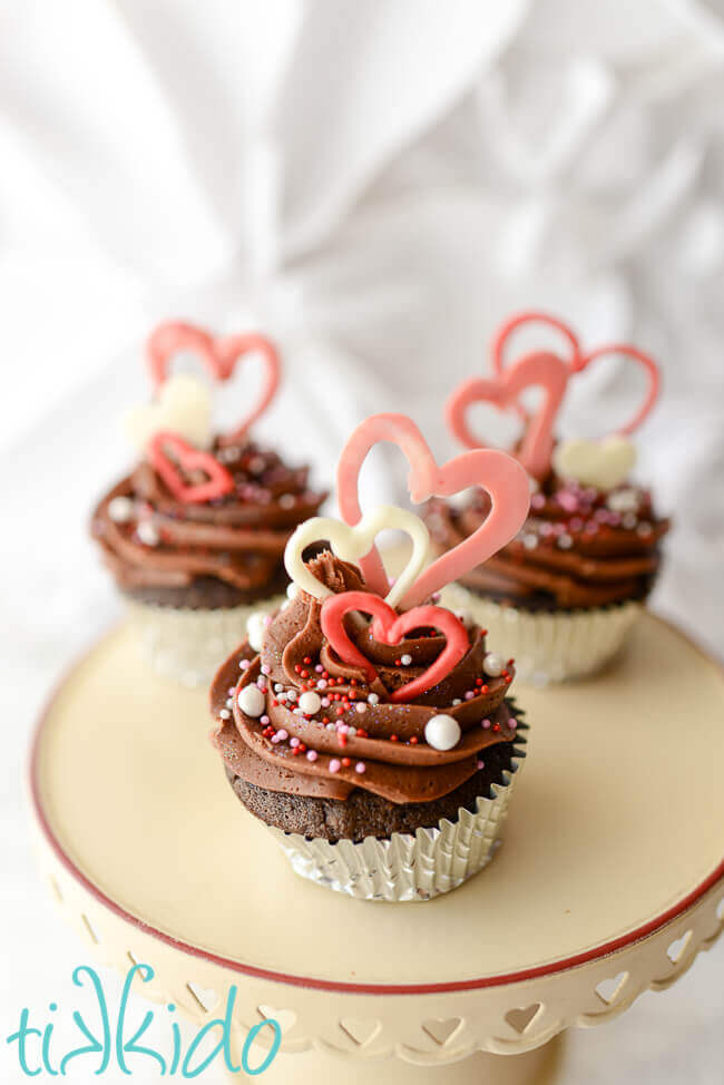 three Valentine's day cupcakes decorated with chocolate heart Valentine's day cupcake toppers